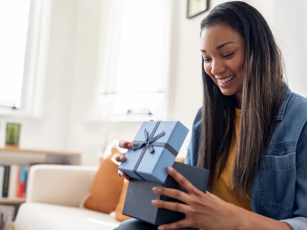 Woman delighted opening a gift